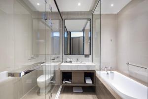 a bathroom with a sink and a tub and a toilet at Hyatt House Shanghai Hongqiao CBD in Shanghai