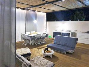 a living room with a blue couch and a table at House in Sicily near beaches in Siracusa