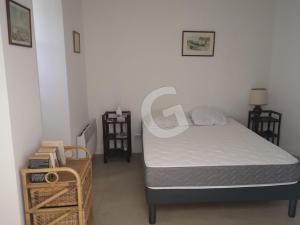 a small bedroom with a bed and a table at Maison de vacances proche plage et centre, La Tranche sur Mer - FR-1-357-335 in La Tranche-sur-Mer +9 photos