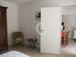 a living room with a table and a chair at Maison de vacances proche plage et centre, La Tranche sur Mer - FR-1-357-335 in La Tranche-sur-Mer