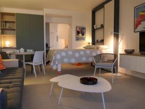 a living room with a bed and a couch and a table at Studio vue mer climatisé, 2 à 4 pers., parking en option à Villeneuve-Loubet Plage - FR-1-252A-131 in Villeneuve-Loubet