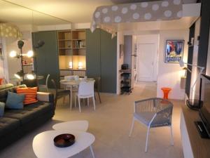a living room with a couch and a table at Studio vue mer climatisé, 2 à 4 pers., parking en option à Villeneuve-Loubet Plage - FR-1-252A-131 in Villeneuve-Loubet