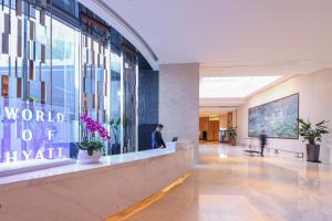 a man standing in the lobby of a building at Hyatt House Shanghai Hongqiao CBD in Shanghai
