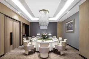 a large dining room with a white table and chairs at Hyatt House Shanghai Hongqiao CBD in Shanghai