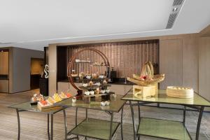 a lobby with two tables and baskets of food at Hyatt House Shanghai Hongqiao CBD in Shanghai