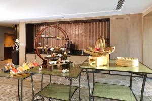 a lobby with two tables with baskets of food at Hyatt House Shanghai Hongqiao CBD in Shanghai
