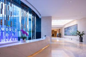 a lobby of a building with plants on the wall at Hyatt House Shanghai Hongqiao CBD in Shanghai