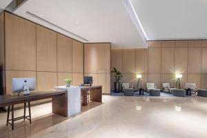 a lobby with a desk with a computer on it at Hyatt House Shanghai Hongqiao CBD in Shanghai