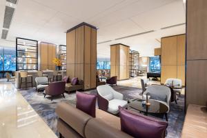 a waiting room with couches and chairs and tables at Hyatt House Shanghai Hongqiao CBD in Shanghai