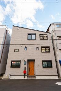 a building with a brown door on the side of it at Osaka Namba Yeon House in Osaka