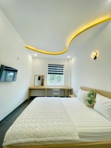 a bedroom with a large white bed and a window at Baly Hotel Bà Rịa City in Bà Rịa +45 photos
