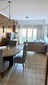 a living room with a couch and a table at Olimpo Apartment 6 Frente al mar-Plaza Colon solo familias! in Mar del Plata