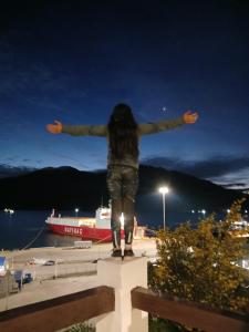 a person standing on a dock with their arms outstretched at Patagon karim 2 in Puerto Cahacabuco