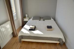 a bedroom with a bed with two towels on it at Le Solférino in Maisons-Laffitte