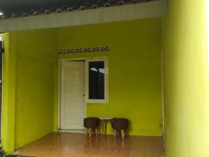 two chairs in a room with a green wall at Kamila House in Bantul