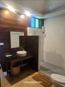 a bathroom with a sink and a toilet at Thanya Beach Resort - SHA Plus in Ko Ngai