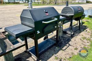 a bbq and a grill sitting next to a street at Cozy Maple House Family Lake Como Retreat in Lake Geneva