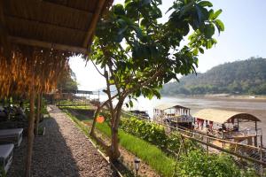 a view of a river with boats on the water at The Belle Rive Boutique Hotel in Luang Prabang