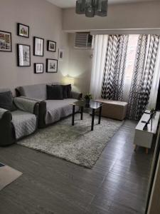 a living room with a bed and a rug at Spacious 2 Bedroom condo unit for rent in Iloilo City +27 photos