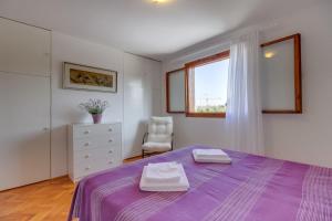 A bed or beds in a room at Vila Mirta