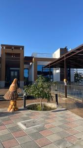 a teddy bear sitting in front of a building at Almaas resthous in Al Fala +18 photos