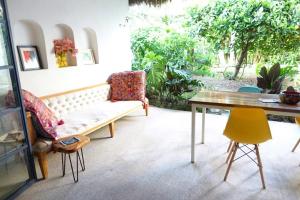 a living room with a couch and a table at Casa Clara 2 bedrooms and 2 kitchens with a Large Garden and a Record Player! in Lo de Marcos +36 photos