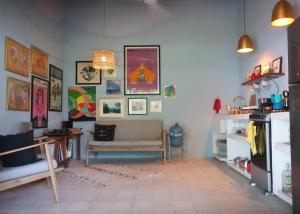 a living room with a couch and a table at Casa Clara 2 bedrooms and 2 kitchens with a Large Garden and a Record Player! in Lo de Marcos