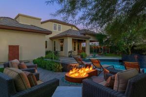 a backyard with a fire pit in front of a house at Villa Perfection in Indio