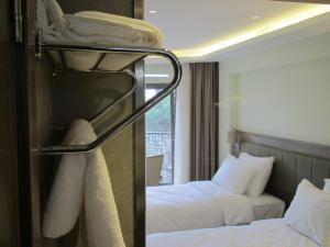 Postel nebo postele na pokoji v ubytování Numi Hotel
