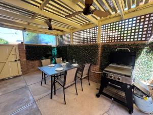 an outdoor patio with a table and a grill at Lakeview 162 in Grange