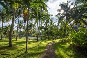 a path through a park with palm trees at Krabi Maritime Resort in Krabi town