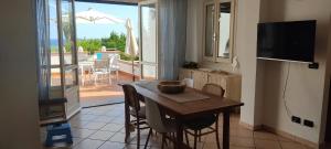 a kitchen with a table with chairs and a refrigerator at Patty's House in Finale Ligure