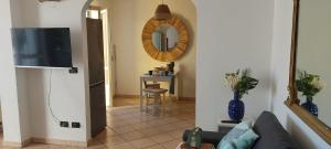 a living room with a couch and a mirror at Patty's House in Finale Ligure