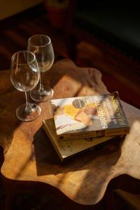 a book sitting on a table with two wine glasses at Astra by The Bombay Home Company in Mumbai +23 photos