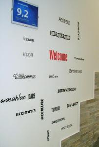 a wall with the names of different brands at WhatsHouse Roma in Rome