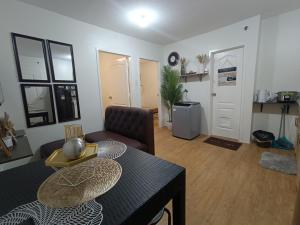 a living room with a table and a couch at Sanremo Oasis by Beau Condotels in Cebu City