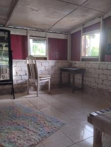 an empty room with a chair and a table at teriang minimal room in Pantai Kok