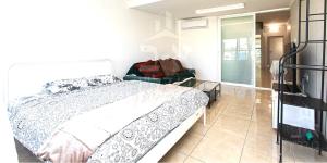a bedroom with a bed and a glass table at Achuza near Horev renovated 3 room in Haifa