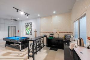 a kitchen with a pool table in a room at The pocket park @Hatyai in Hat Yai