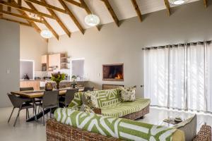 a living room with a couch and a table at Perlemoentjie in Britannia Bay