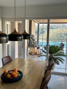 a dining room with a table with a bowl of fruit at Apartment Stella in Rabac +13 photos