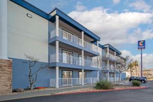 a blue apartment building with a parking lot at Comfort Suites Red Bluff near I-5 in Red Bluff