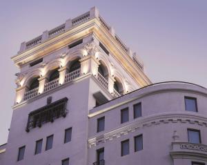 a white building with an ornate tower on top of it at NH Collection Buenos Aires Jousten in Buenos Aires