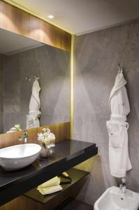 a bathroom with a sink and a mirror at NH Collection Buenos Aires Jousten in Buenos Aires
