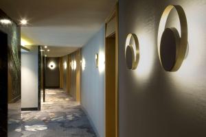 a hallway with two mirrors on the wall at NH Collection Buenos Aires Jousten in Buenos Aires