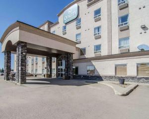 a hotel building with a sign on top of it at Quality Inn & Suites in Grande Prairie