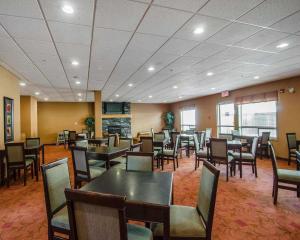 a dining room with tables and chairs in a restaurant at Quality Inn & Suites in Grande Prairie