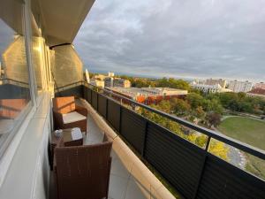 a balcony with a view of a city at Prométheusz Apartman in Szekszárd