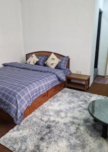 a bedroom with a bed and a coffee table at MYRA Apartment 3BHK in Bālāju