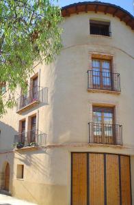 a white building with windows and balconies on it at Casa Plana in Colungo